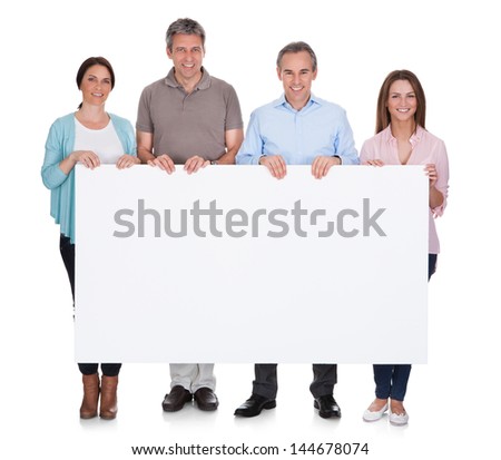 Group Of Happy People Holding Placard Over White Background