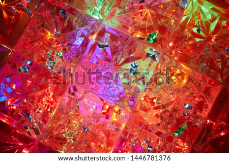 Red color dominates on a multi-colored background with light distortions