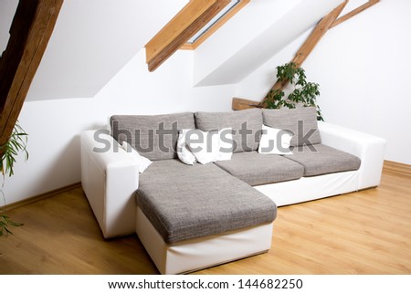 White attic room with a sofa
