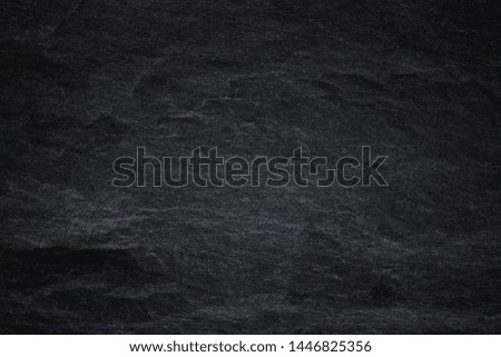 Dark grey black slate background or natural black stone texture. Black stone wall.