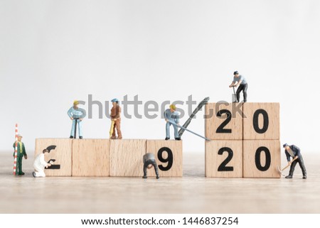 Miniature worker team create number 2020 and remove number 2019  , Happy new year 2019 concept