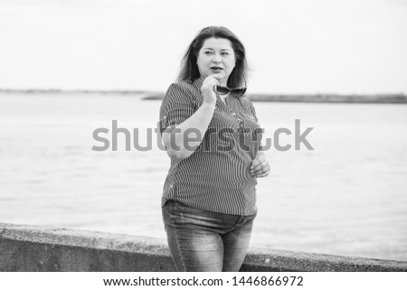 Sad Simple plump middle aged woman thinking about something, crisis of middle age and problems among overweight people