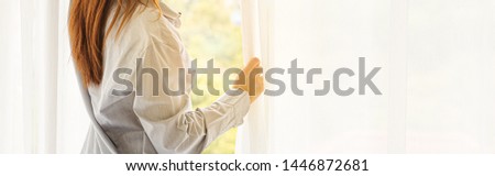 Young beauty woman wake up and stand in front of window in the morning, Cropped image
