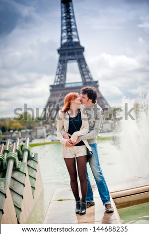 Lovers hugging in Paris with the Eiffel Tower in the Background