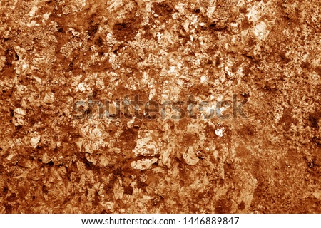 Old stone surface in orange tone. Abstract architectural background and texture for design.