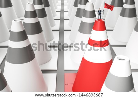 Businessman with victory flag standing on red and white traffic cone. Success and growth concept.