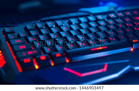 computer gaming keyboard illuminated in dark. pc gaming concept.