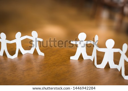Two paper human chains disconnect or loosing doll in a role of team, teamwork or connection concept Royalty-Free Stock Photo #1446942284