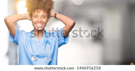 Young african american doctor woman over isolated background Relaxing and stretching with arms and hands behind head and neck, smiling happy