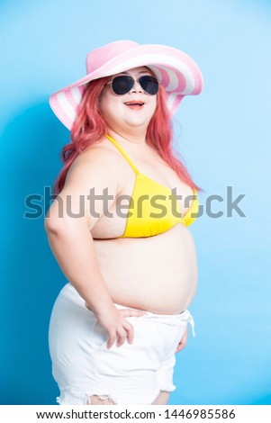 plus size asian girl is happy in summer and isolated in blue background