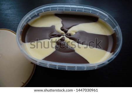 Chocolate paste with hazelnuts in an oval box on te table