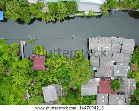 Coconut plantations and residential communities along the banks of the canal in Bangkok that are still green areas in the city center. Photos from aerial drone