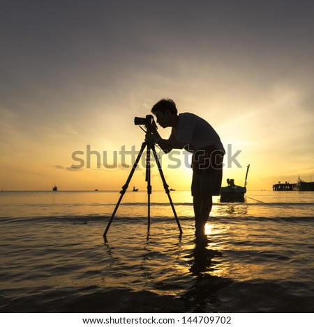 The Photographer takes a good shot on the Huahin  beach, Thailand