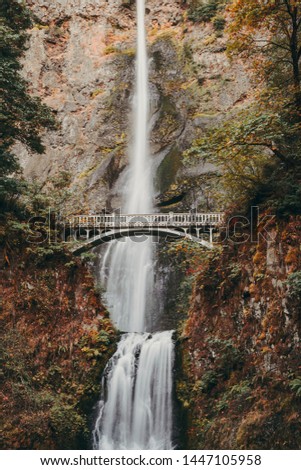 Multnomah Falls in the fall with nobody on Benson Bridge, long exposure with flowing water in the Columbia River Gorge, Oregon, USA Royalty-Free Stock Photo #1447105958