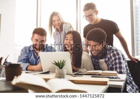 Exams preparation. Multiracial students preparing for exams in library, using laptop together Royalty-Free Stock Photo #1447125872