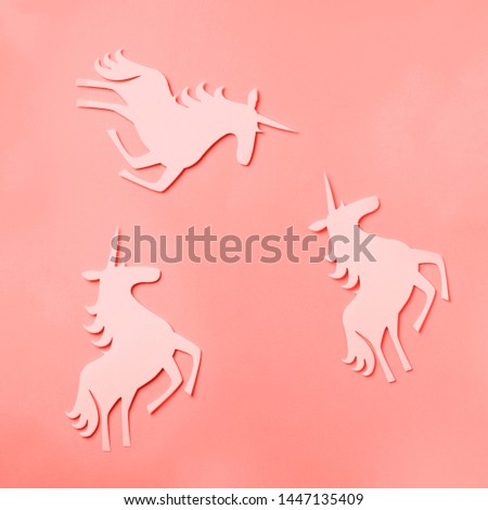 Creative unicorn pattern on trendy coral color background. Abstract art texture Minimal fantasy concept. Banner. Square crop.