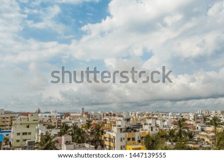 A scenic aerial view of a town with interesting dark cloud formation, as photographed from building terrace and real estate development