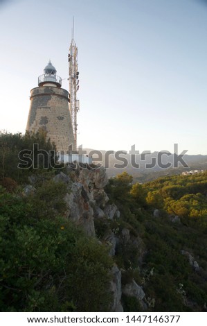 Lighthouse on a hill and sunset in the mediterranean coast