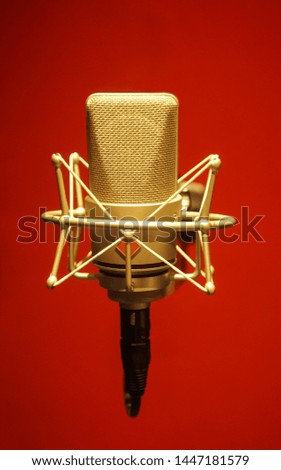 Red background microphone In a professional recording room                    