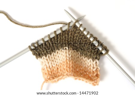 Knitting a color fluffy wooll in shape of house, with knitting needles. Isolated on white Royalty-Free Stock Photo #14471902