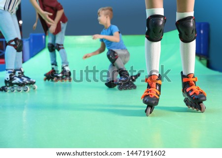 Family having fun at roller skating rink, closeup