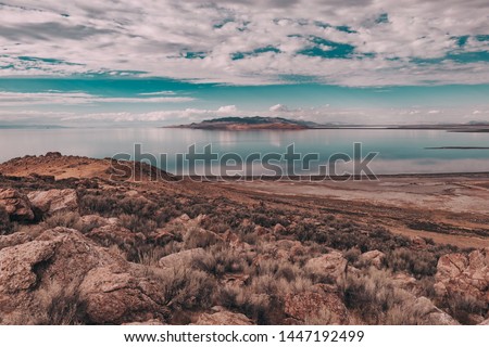 Views of Great Salt Lake at Antelope Island State Park, Utah, USA. Desert landscape, water reflections, dramatic clouds.   Royalty-Free Stock Photo #1447192499