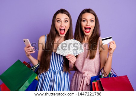 Close up photo two people beautiful she her models ladies hands arms plastic pay card fan usa bucks many packs scream shout yell glad wear colorful dresses isolated purple violet bright background