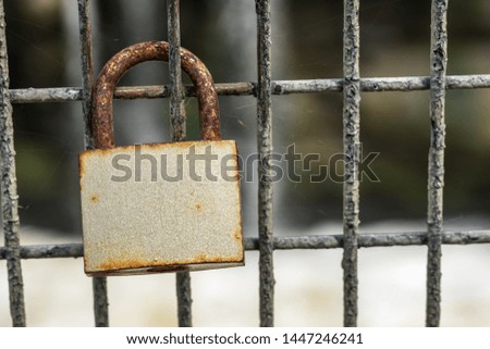 Rusted old love locks on railing
