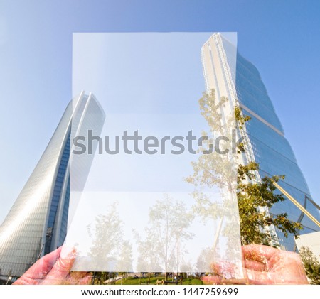 Double exposure make with hand holding white paper and height building, Business Trading concept.
