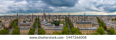 Large aerial panorama picture of the Paris cityscape with the Tour Montparnasse and the Eiffel Tower including Avenue Marceau, Avenue d'Iéna, Avenue Kléber and Avenue Victor-Hugo on a cloudy day.