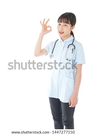 Young nurse giving OK sign
