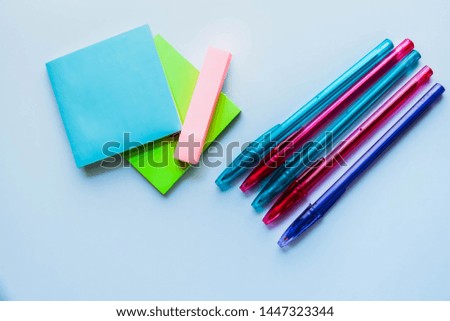 Paper notes and colorful pens on white background. Stickers for taking notes on a white background.