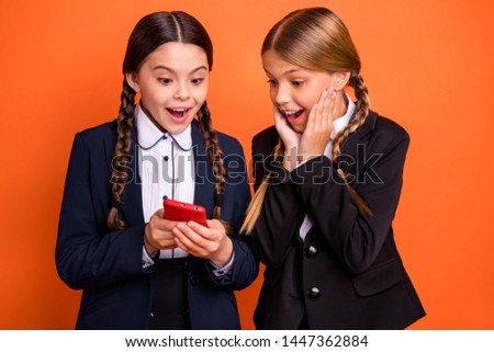 Close up photo two beautiful people she her little sisters lady hands arms cheeks telephone show instagram followers wear formalwear shirt blazer school form bag isolated bright orange background