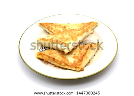On a white background with a white border the plate with all the delicious triangles of dough