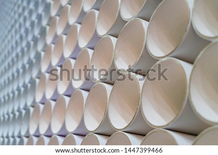 The circle of cylinder made from paper recycle to arranged together like relationship chain ,Interior design to decorated the wall from waste materials to create more value.