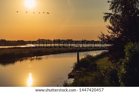 Splendid countryside landscape by the water before sunset, in summer - Groningen, Netherlands