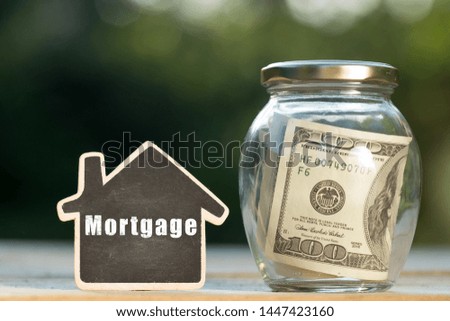 Mortgage - written on the little house shape tag - real estate concept