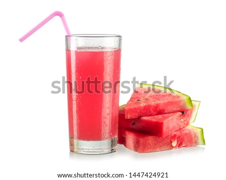 Glass with watermelon juice and fruit slices, close up