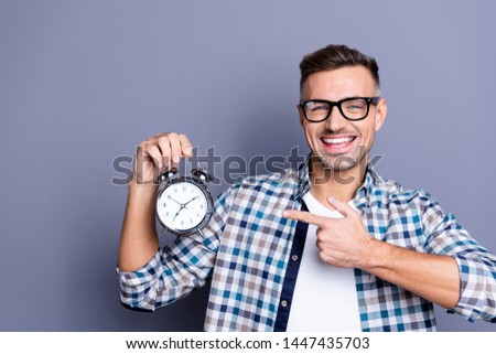 Close up photo handsome he him his guy arm hand indicating cool old-fashioned retro metal alarm excited easy awakening not miss job work wear casual plaid checkered shirt isolated grey background