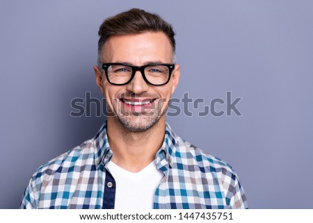 Close up photo handsome attractive he him his guy intelligent reliable manager person peacefully cute funny smile neat bristle beard wear specs casual plaid checkered shirt isolated grey background