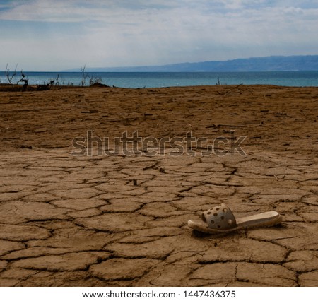 View to Dead sea landscape with lost one rubber slipper in foreground, Jordan