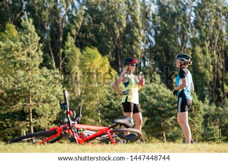 Women cyclist doing exercises after riding a bike outdoors in the park