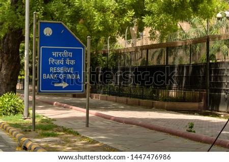 Blue NDMC street board for Reserve Bank of India (RBI) building in Delhi, India. India's central bank, which controls the issue and supply of the Indian rupee Royalty-Free Stock Photo #1447476986