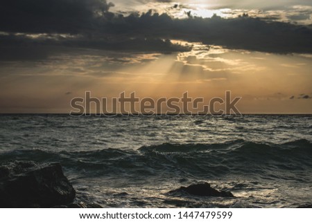 a beautiful sunrise at the sea. the sun's rays through the clouds. Sea storm.