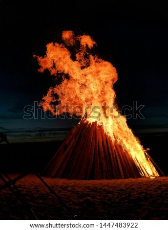 Large night flame fire on shore