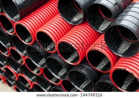 Red plastic tubes in the warehouse.
