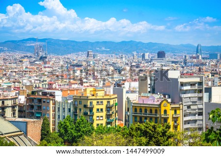 Barcelona city skyline with colorful buildings and Sagrada familia under construction