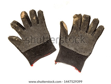 Old dirty work gloves isolated on white background close-up