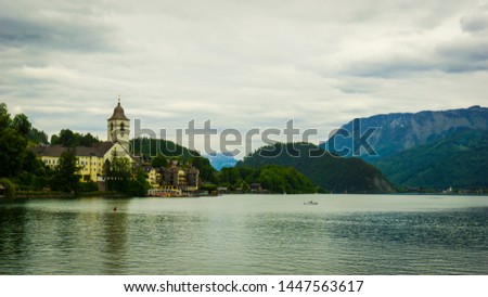 Beautiful Aps landscape with big lake,  green mountains, valley, forest and church on the Coast