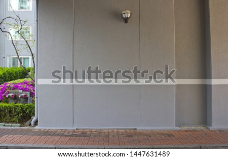 Gray concrete wall with white lines.